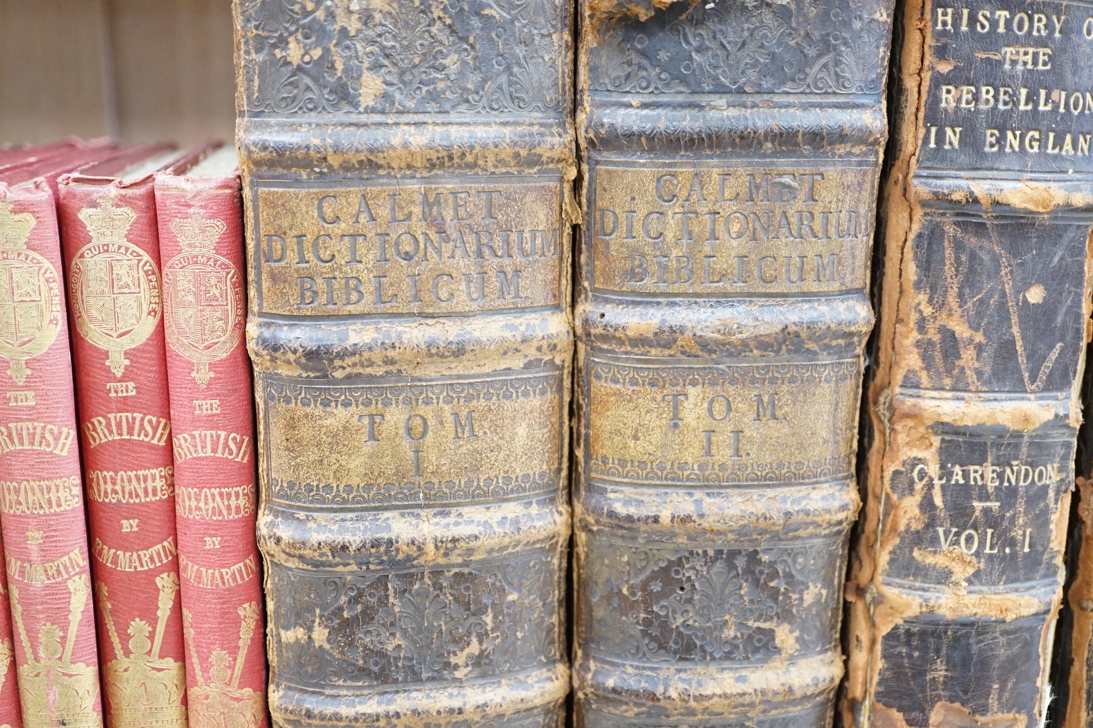 A quantity of leather and cloth bound books and a poster